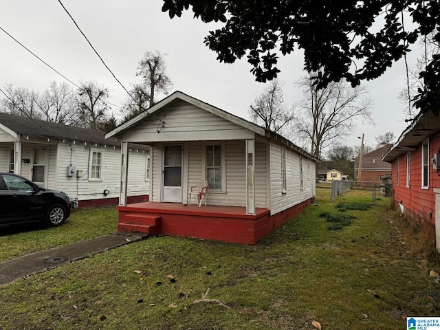 bungalow-style house featuring a porch and a front yard