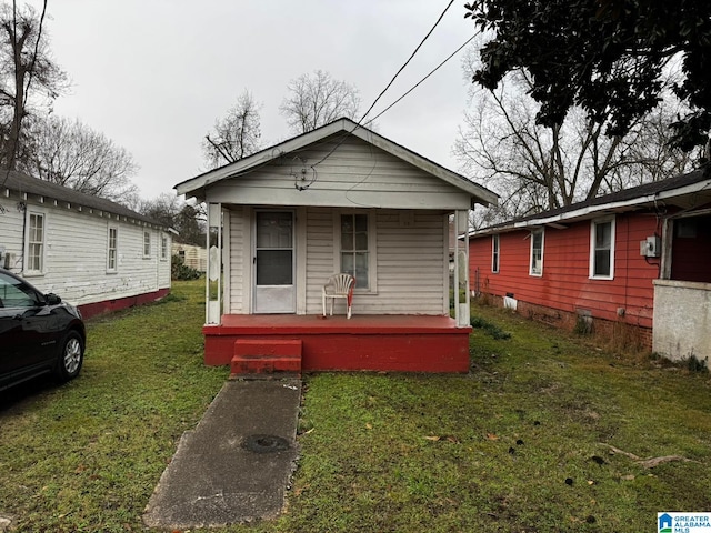 bungalow-style house with a porch and a front lawn