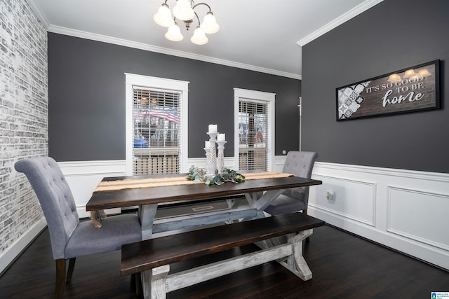 dining area with dark hardwood / wood-style flooring, a chandelier, and ornamental molding