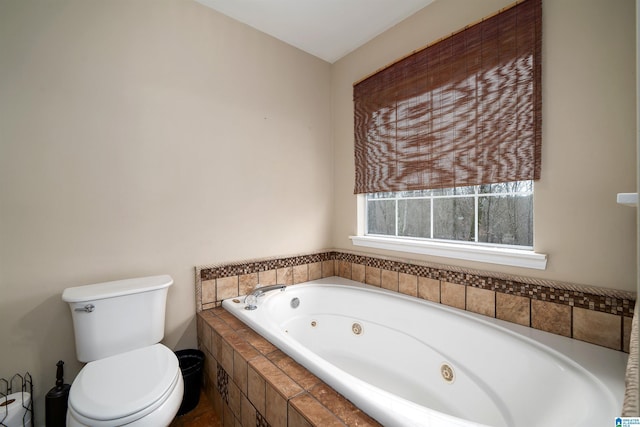 bathroom featuring a relaxing tiled tub and toilet