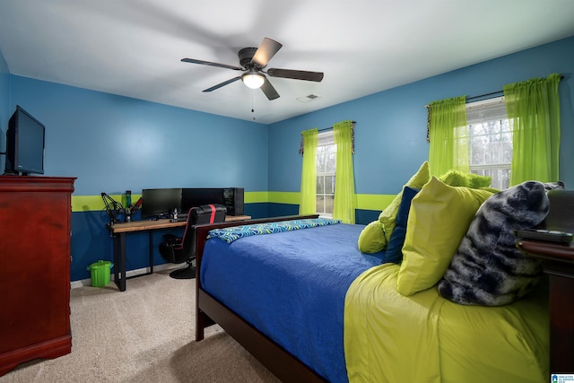 bedroom featuring light carpet, multiple windows, and ceiling fan