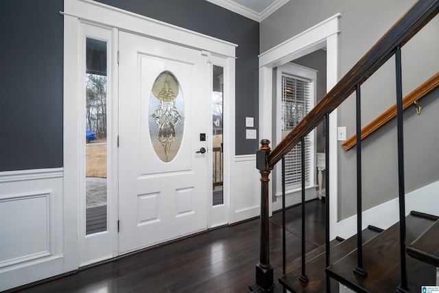 foyer featuring crown molding and dark wood-type flooring