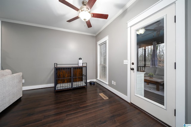 interior space with ceiling fan, dark hardwood / wood-style flooring, and ornamental molding