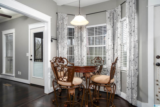 dining area with dark hardwood / wood-style flooring and ornamental molding