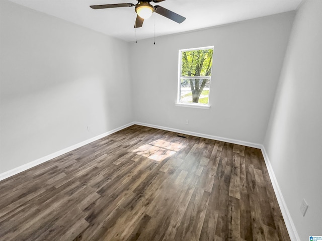 spare room featuring dark hardwood / wood-style floors and ceiling fan