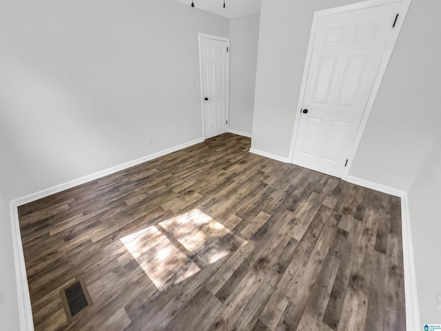 spare room featuring dark hardwood / wood-style floors