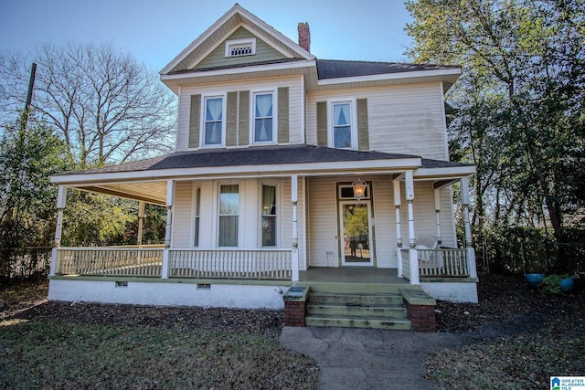 victorian-style house with a porch, crawl space, a shingled roof, and a chimney