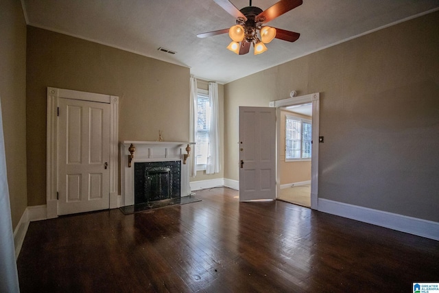 unfurnished living room featuring hardwood / wood-style flooring, ceiling fan, and a premium fireplace