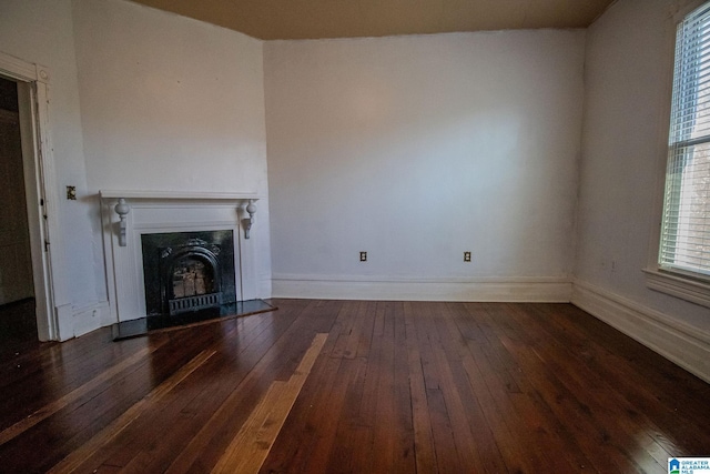 unfurnished living room with dark hardwood / wood-style floors