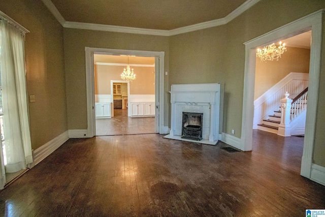 unfurnished living room featuring a notable chandelier, ornamental molding, and a fireplace