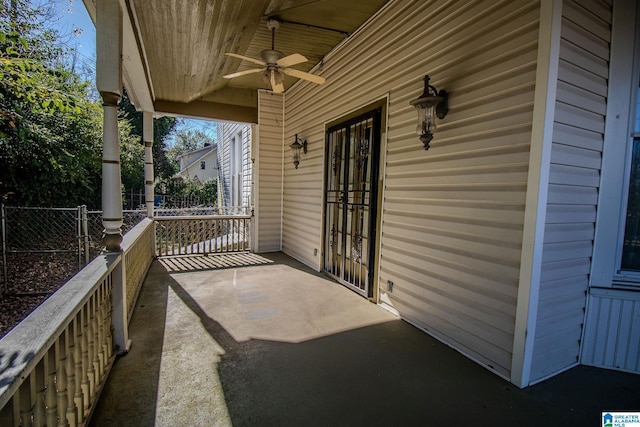 view of patio with ceiling fan and a porch