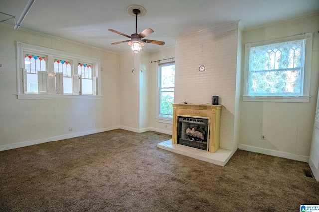 unfurnished living room with carpet floors, a wealth of natural light, and ceiling fan