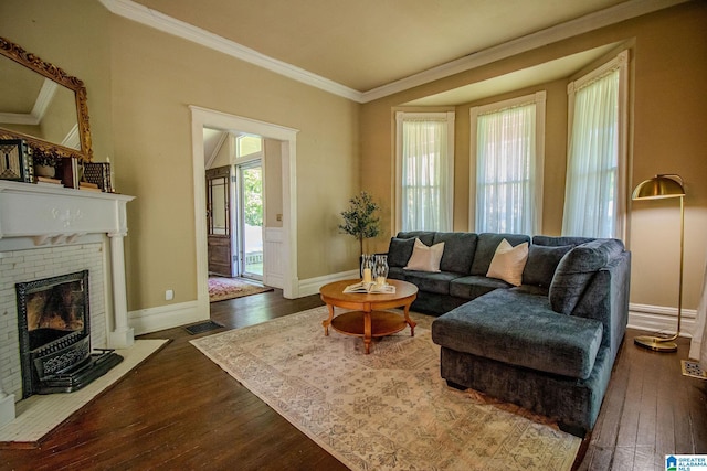 living area with dark wood finished floors, baseboards, visible vents, crown molding, and a fireplace