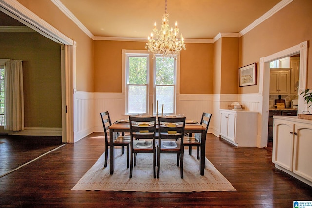 dining room featuring wainscoting, crown molding, a notable chandelier, and dark wood-type flooring