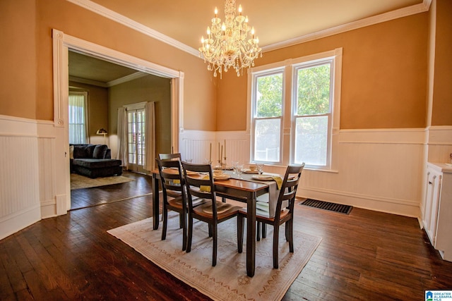 dining space with wainscoting, an inviting chandelier, dark wood-style flooring, and visible vents