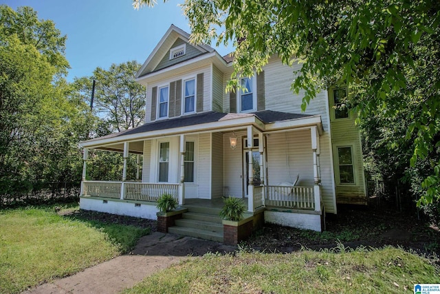 view of front of house with crawl space, a front lawn, and covered porch