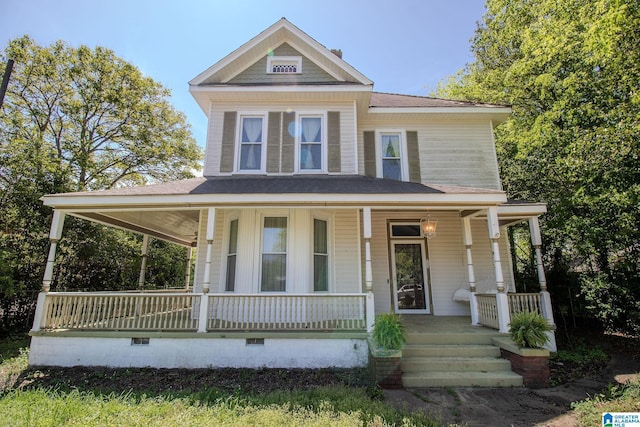 view of front facade featuring crawl space, a shingled roof, and covered porch