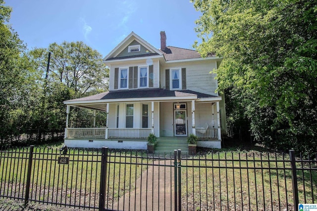 view of front of home featuring a chimney, a fenced front yard, a front yard, and covered porch