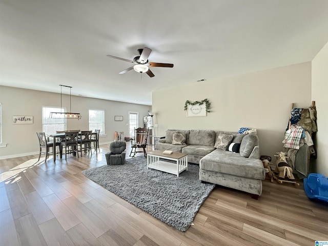 living room with ceiling fan and light hardwood / wood-style floors