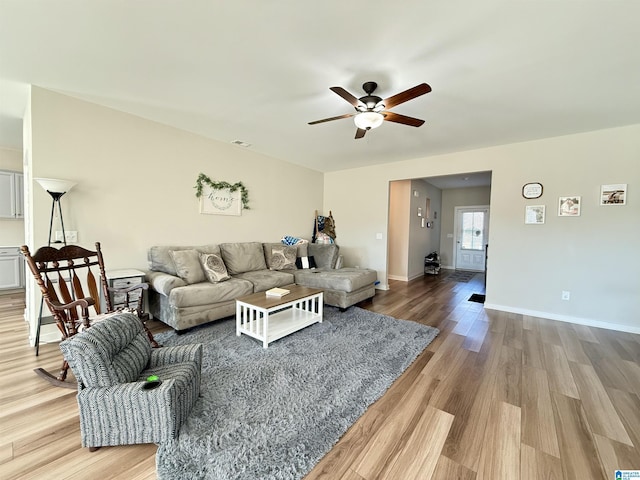 living room with ceiling fan and light hardwood / wood-style floors