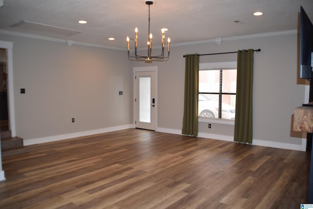 unfurnished living room with a chandelier, dark hardwood / wood-style floors, and ornamental molding