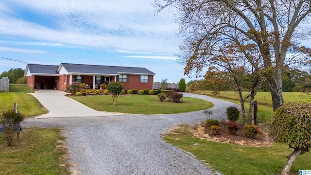 single story home featuring a front lawn and a carport