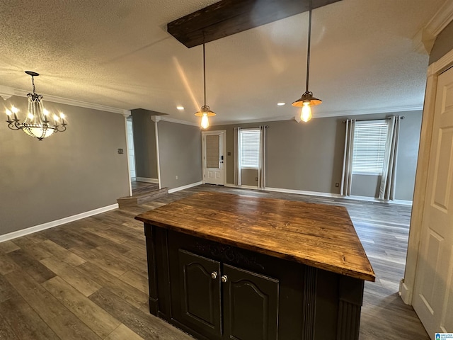 kitchen with wood counters, pendant lighting, dark brown cabinets, and ornamental molding