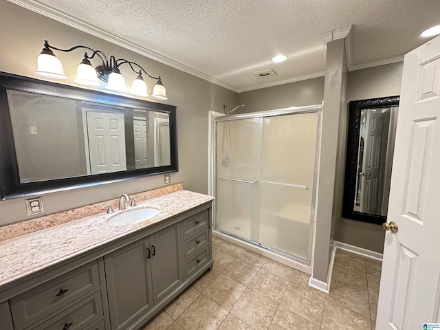 bathroom with crown molding, a shower with door, vanity, and a textured ceiling