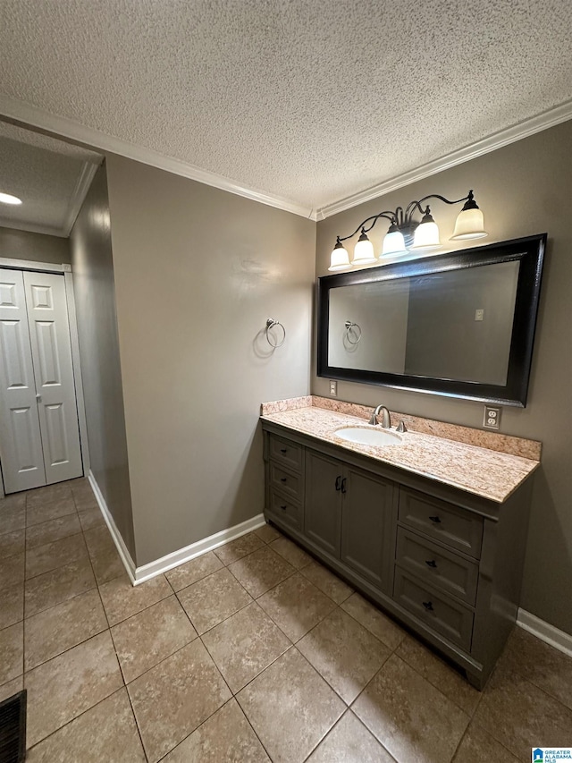 bathroom featuring vanity, a textured ceiling, crown molding, and tile patterned flooring