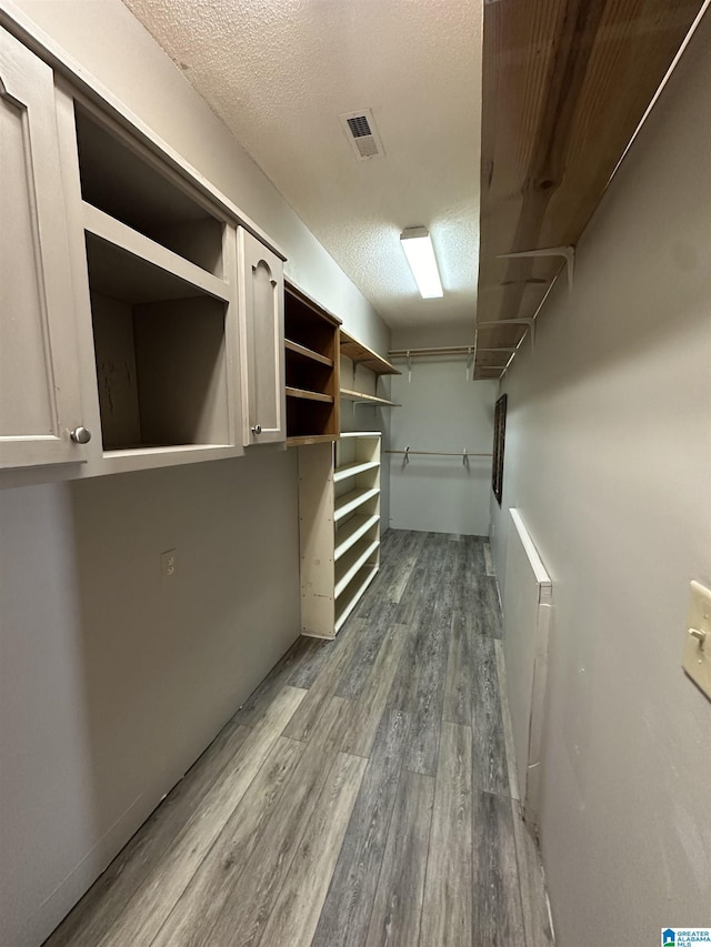 spacious closet featuring hardwood / wood-style floors