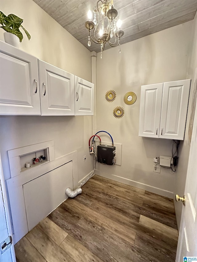 laundry room featuring hardwood / wood-style flooring, cabinets, hookup for a washing machine, and a chandelier