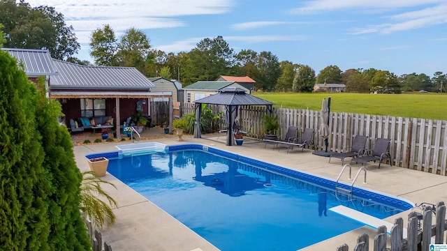 view of pool featuring a gazebo, a diving board, and a patio