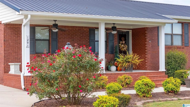 doorway to property featuring covered porch and ceiling fan