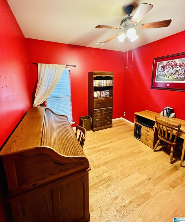 home office featuring light wood-type flooring and ceiling fan