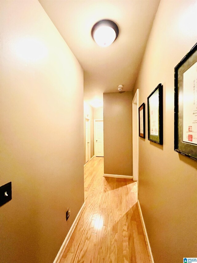 hallway with hardwood / wood-style floors