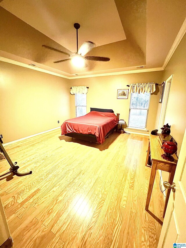 bedroom with hardwood / wood-style floors, a raised ceiling, ceiling fan, ornamental molding, and pool table