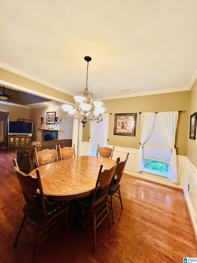 1069 Avalon Dr, Moody, AL 35004 - dining space featuring ornamental molding, wainscoting, light wood finished floors, and a chandelier