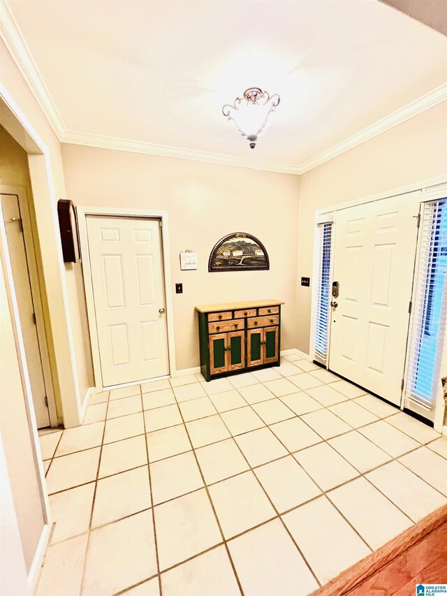 tiled entrance foyer featuring ornamental molding