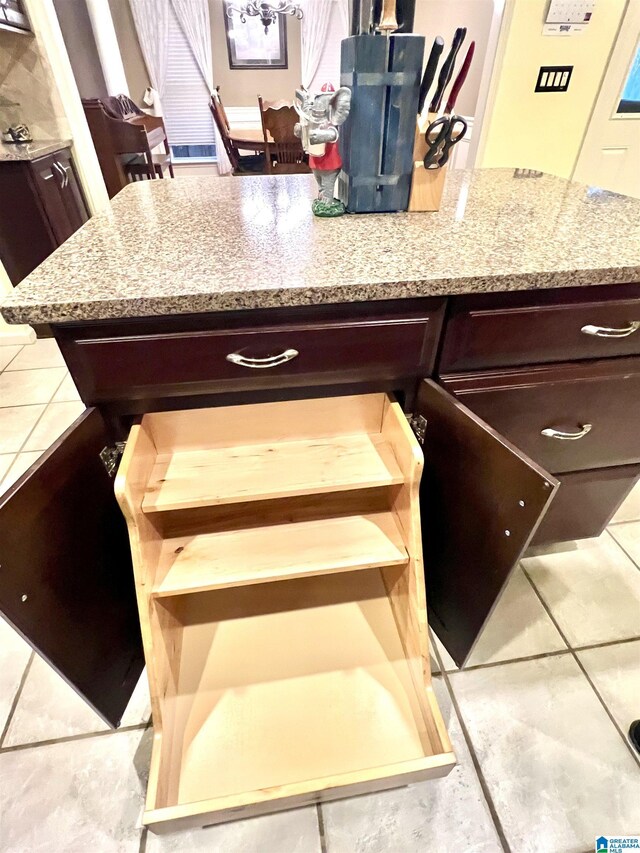 interior details with light stone counters and dark brown cabinetry