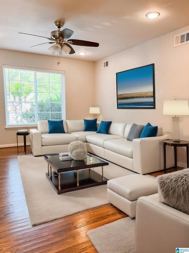 living room with hardwood / wood-style floors and ceiling fan