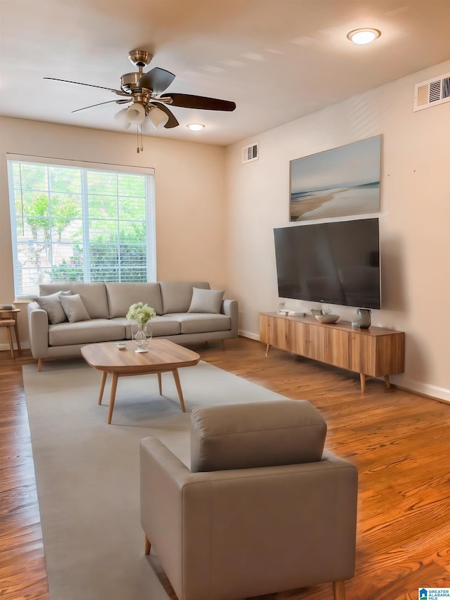 living room with ceiling fan and light wood-type flooring