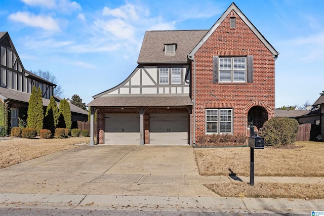 english style home featuring a garage