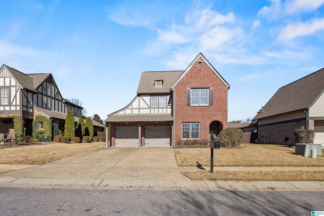 tudor-style house featuring a garage