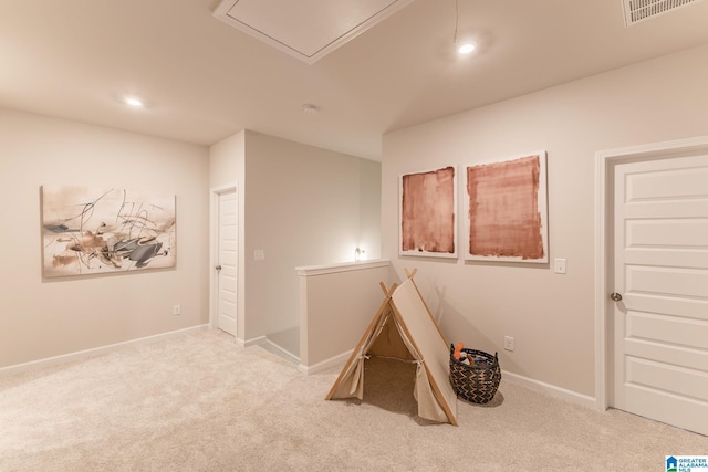 recreation room featuring light colored carpet