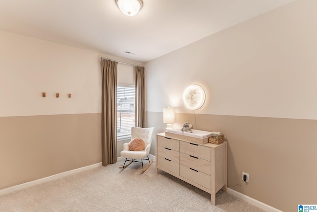 sitting room featuring light colored carpet