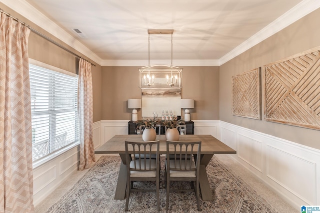 carpeted dining room with a notable chandelier and ornamental molding