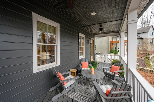 wooden deck featuring ceiling fan and a porch