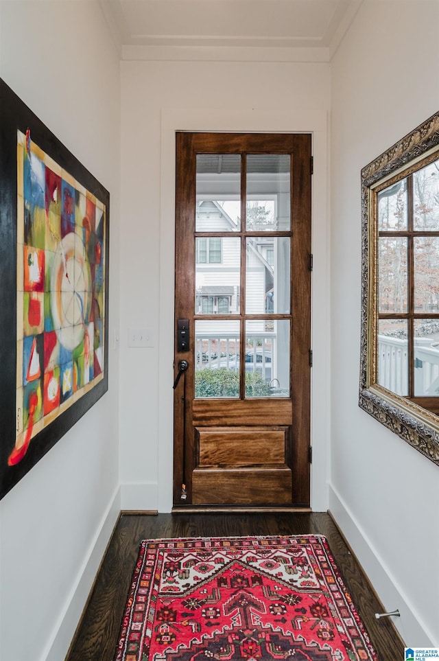 doorway to outside with dark hardwood / wood-style floors, a healthy amount of sunlight, and ornamental molding