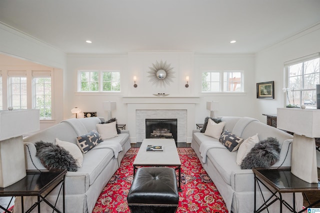 living room featuring a wealth of natural light and ornamental molding