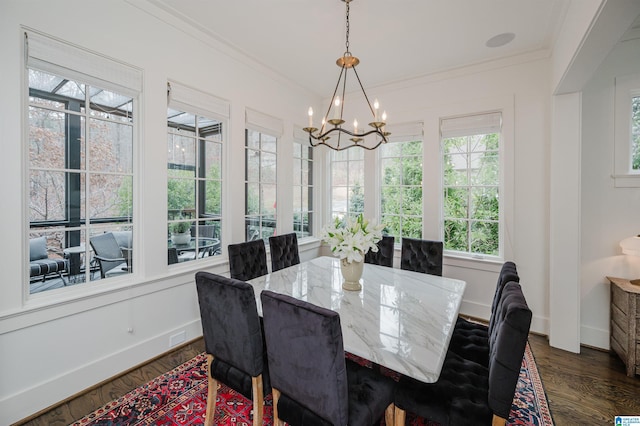 dining space with a notable chandelier, ornamental molding, and dark wood-type flooring